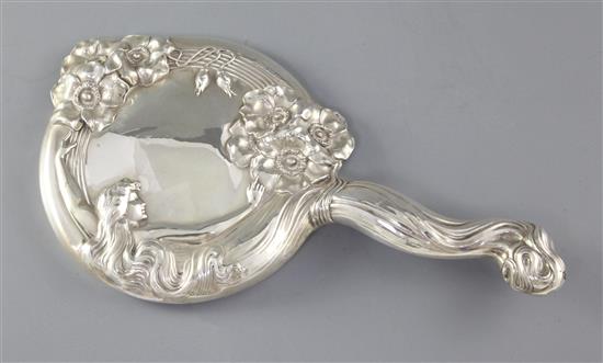 An early 20th century Art Nouveau sterling silver mounted hand mirror, 29.2cm.